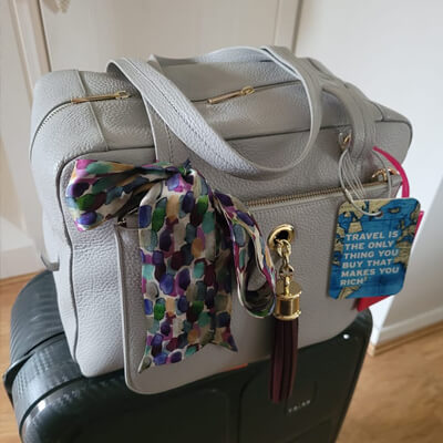 Jessica 2 in 1 zipped tote on top of a suitcase 