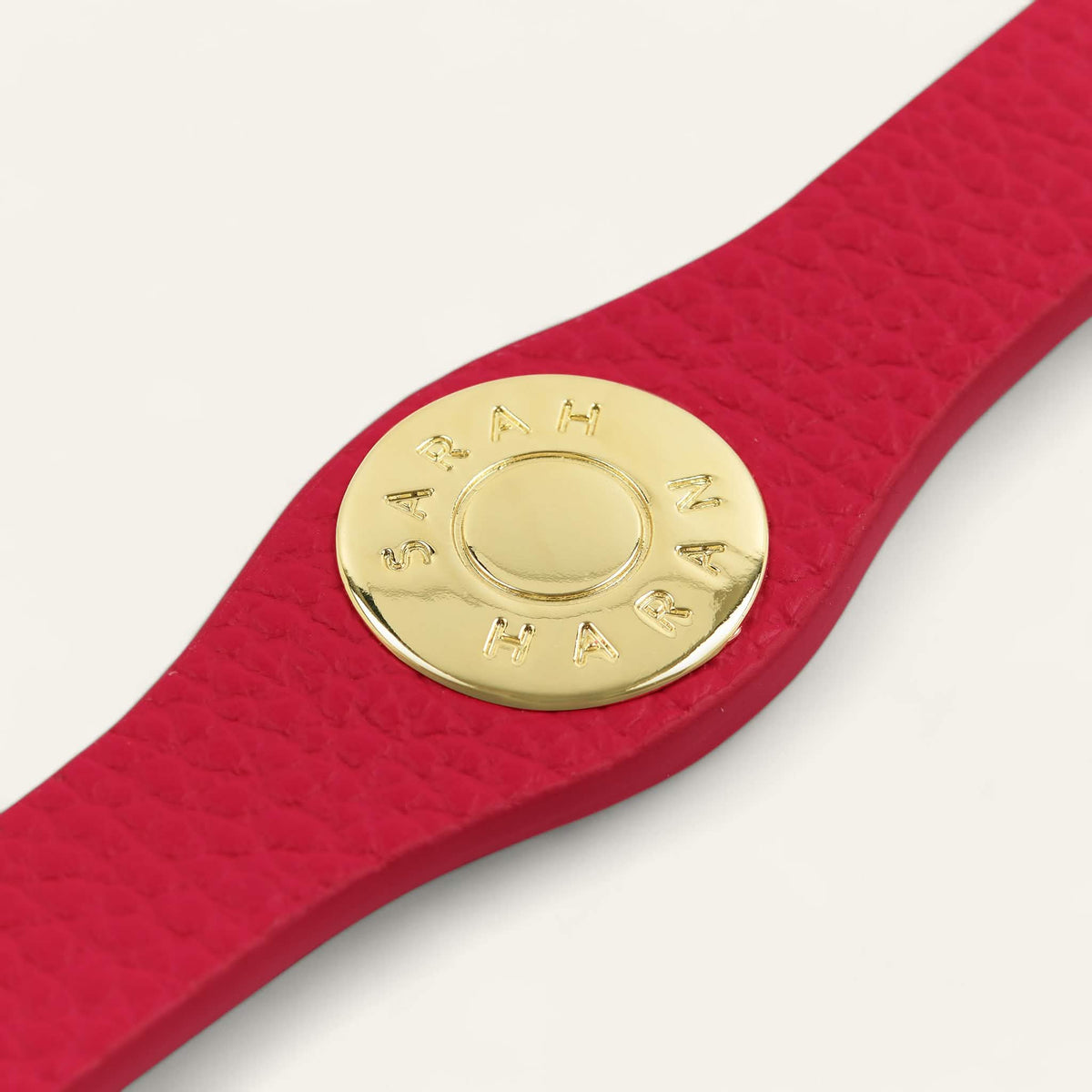 Pillarbox Red Sarah Haran Deco Logo with Gold hardware detail